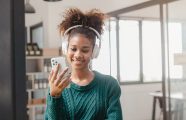 Pretty young african american student woman listen to music with headphones